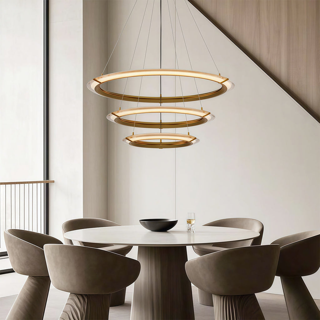 Gold finish chandelier hanging in a contemporary dining area