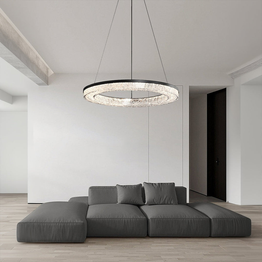 Contemporary LED ring pendant hanging above a dining table