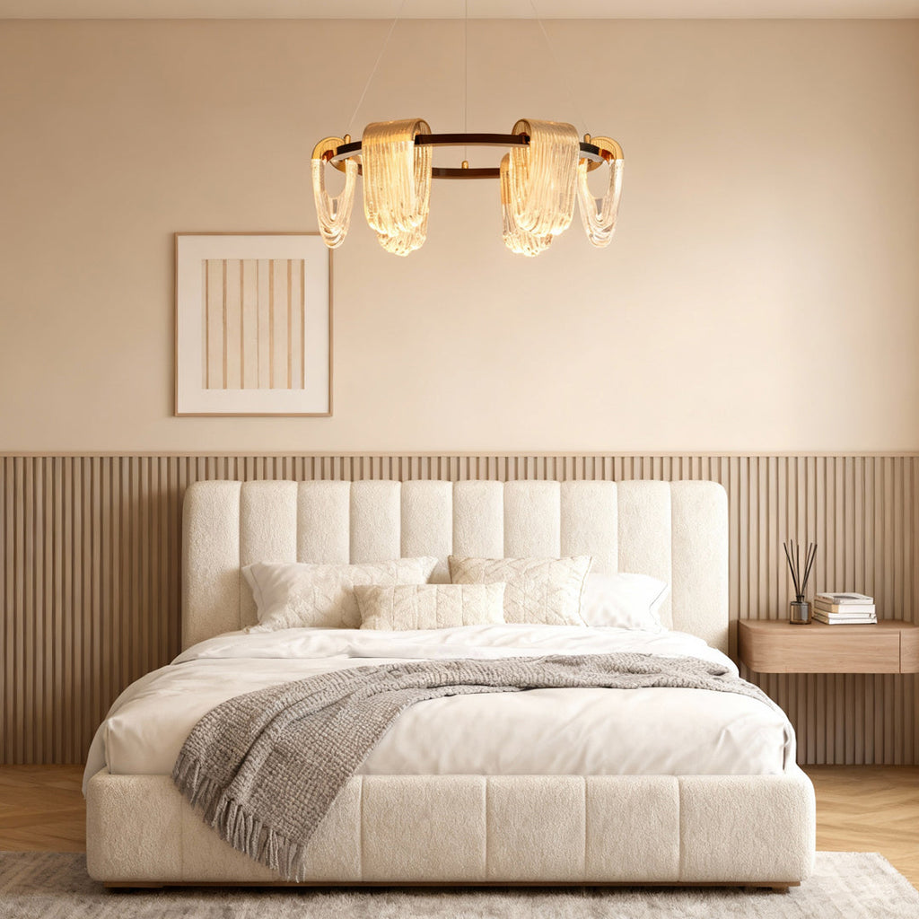 Circular chandelier hanging above a bed in a bedroom