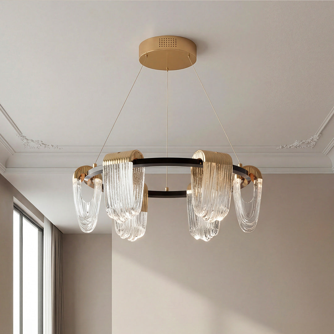 Black and gold circular chandelier with draped glass
