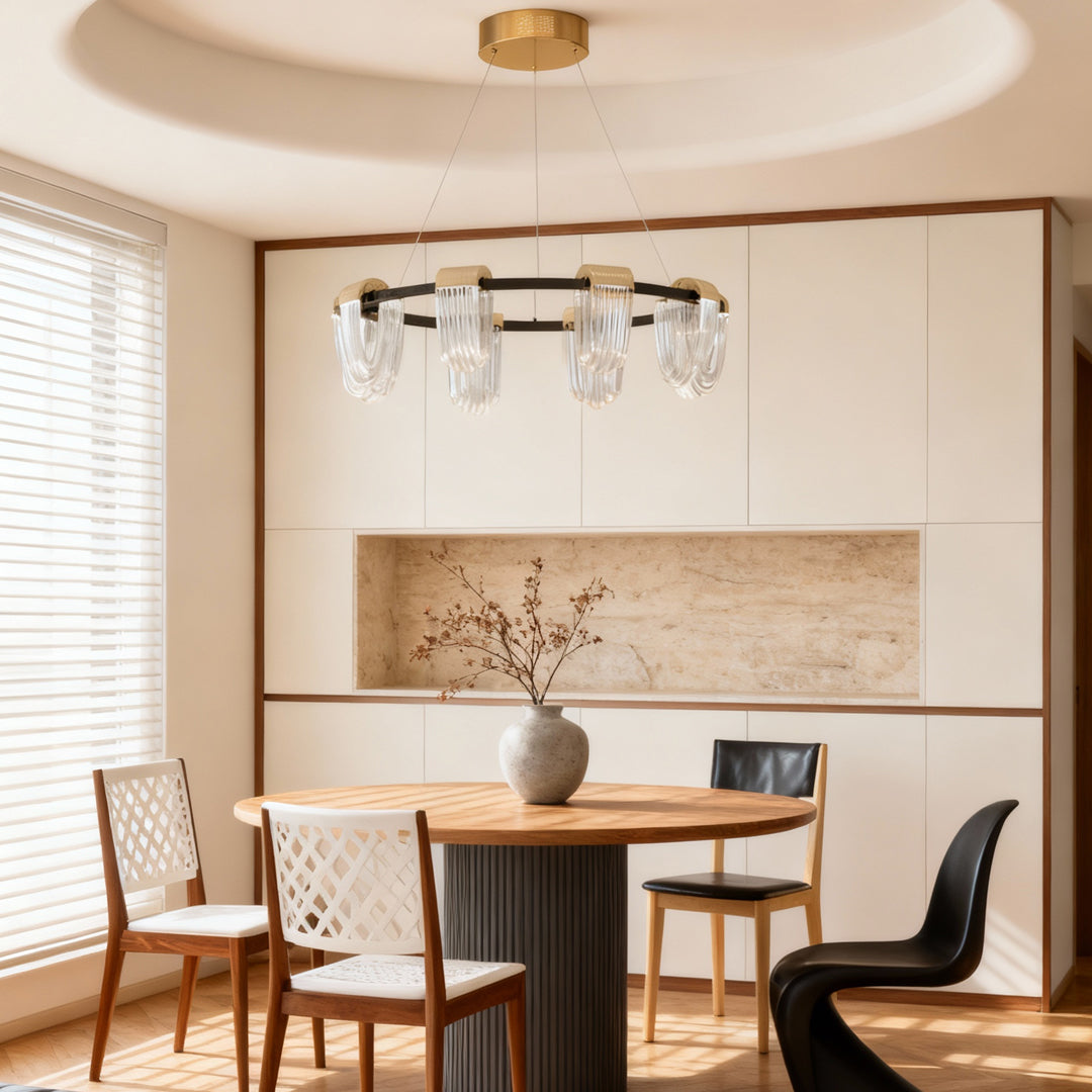 Circular chandelier hanging above a dining table