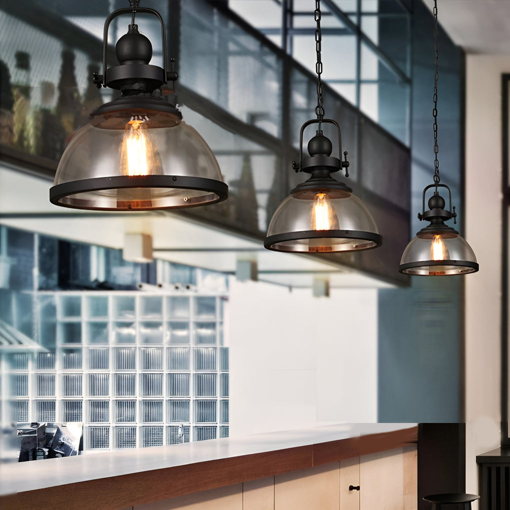 Several clear glass pendant lights hanging in a row