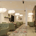 Cloud pendant light hanging in a modern cafe interior