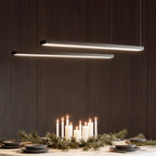 Linear pendant lights suspended over a dining space