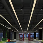 Linear pendant lights hung from an industrial ceiling