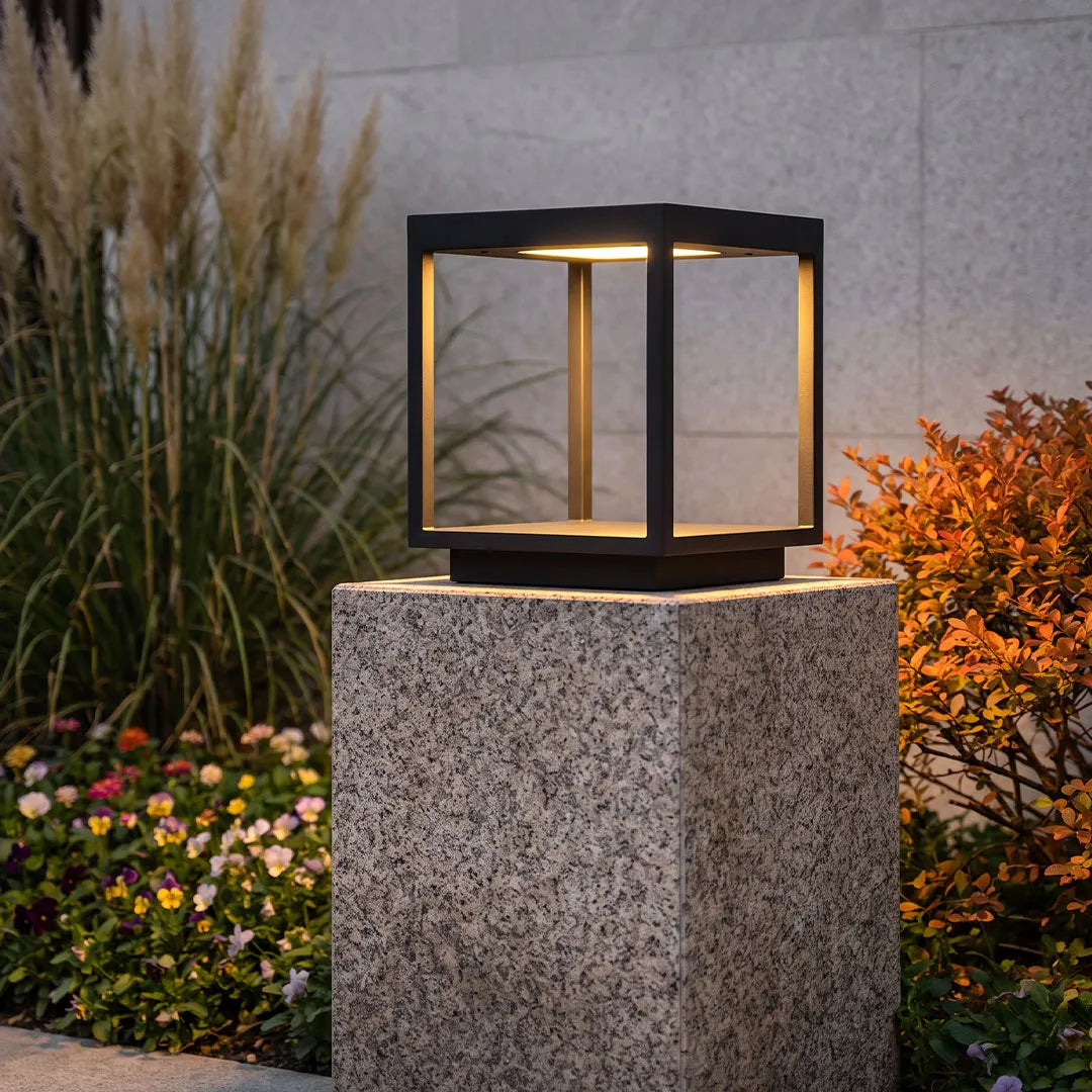 Square open-frame pillar light on a textured stone post