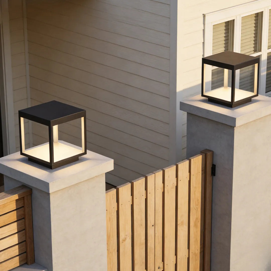 Open-frame square pillar light on a post at a modern home entrance