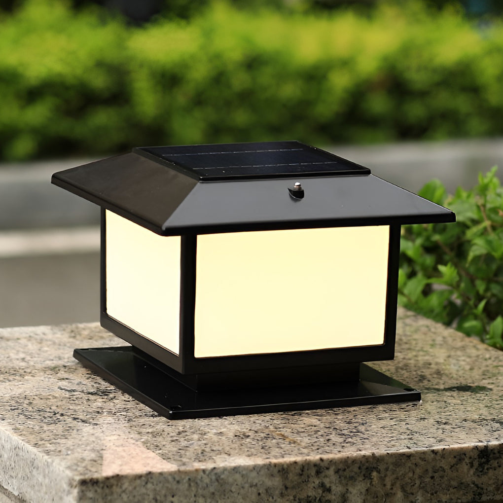 Black flat-roof pillar light mounted on a stone pillar