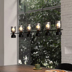 Glass pendant chandelier hanging beside a window view