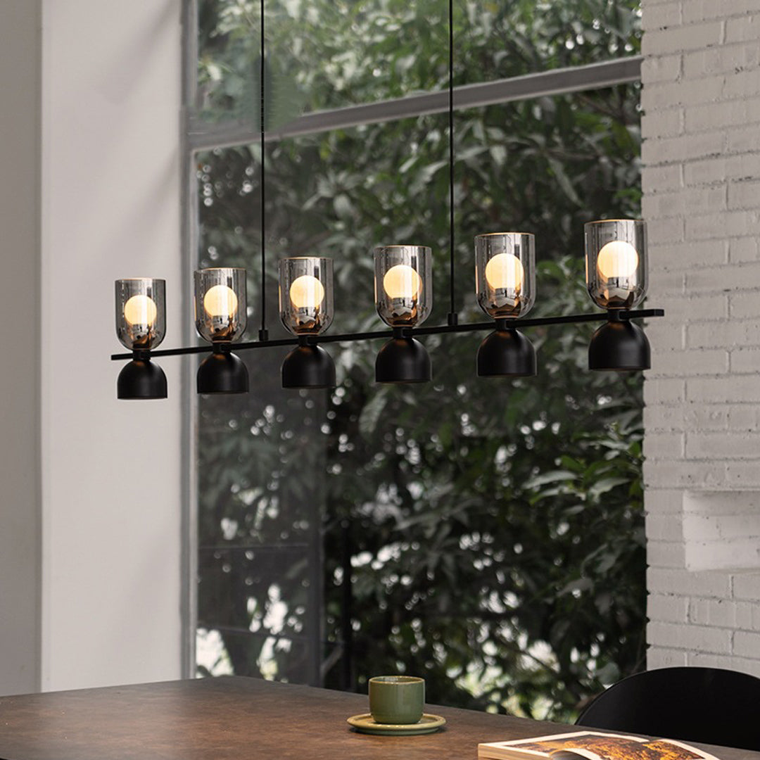 Glass pendant chandelier hanging beside a window view