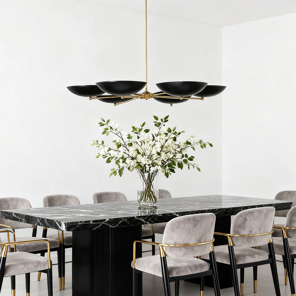 Chandelier hanging above a marble table with velvet chairs