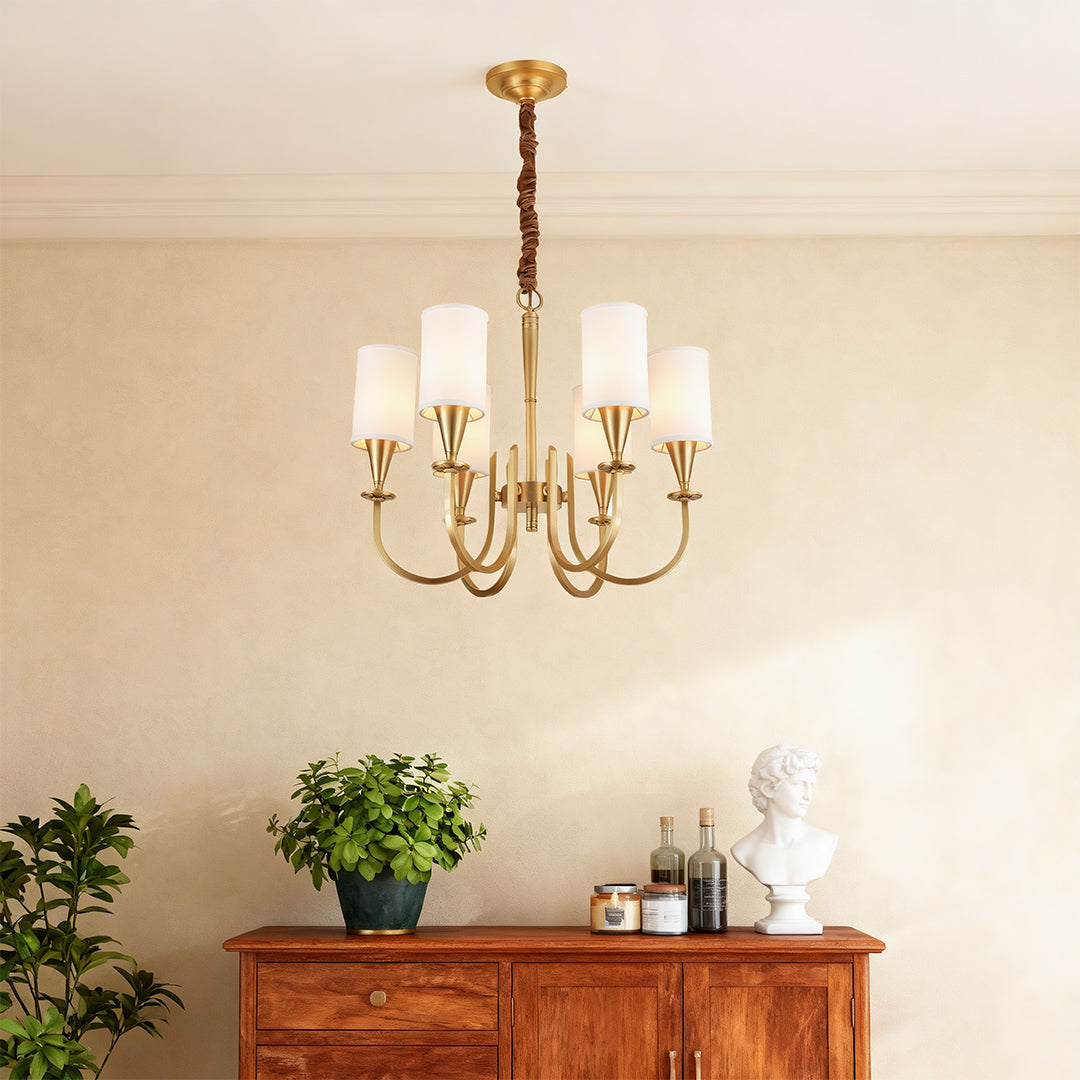 Copper chandelier above a wooden console in a warm interior