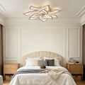 Decorative line-art ceiling fan with light in a bedroom