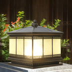 Decorative pillar light mounted on a garden wall