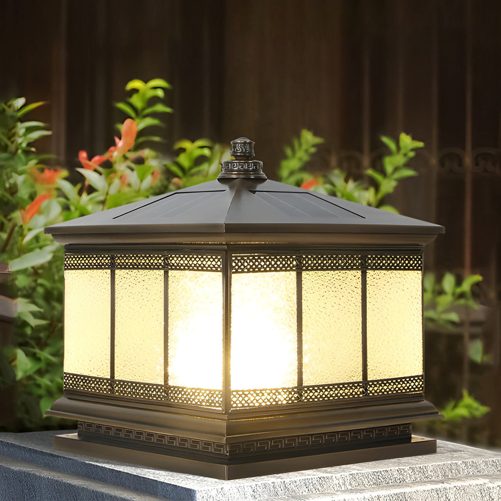Decorative pillar light mounted on a garden wall