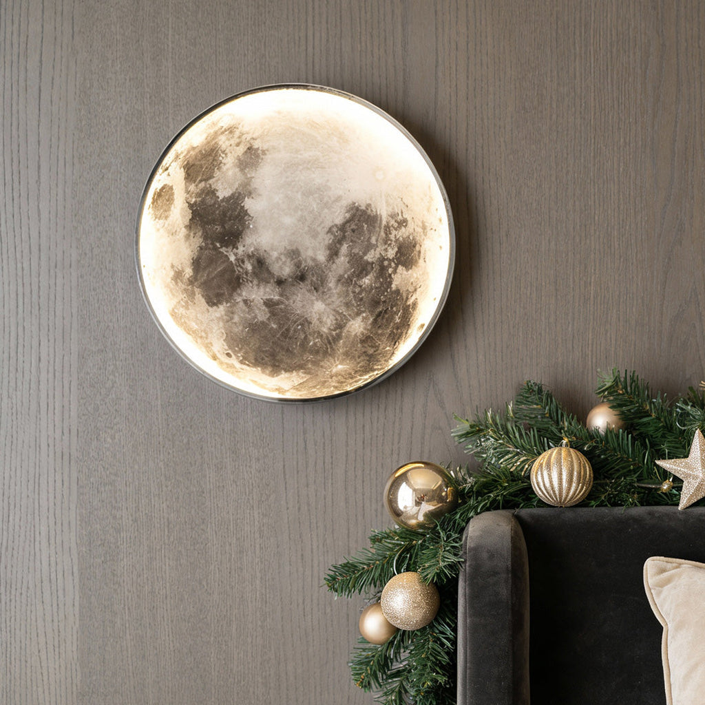 Full moon wall lamp beside a Christmas garland in cozy light