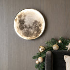 Full moon wall lamp beside a Christmas garland in cozy light