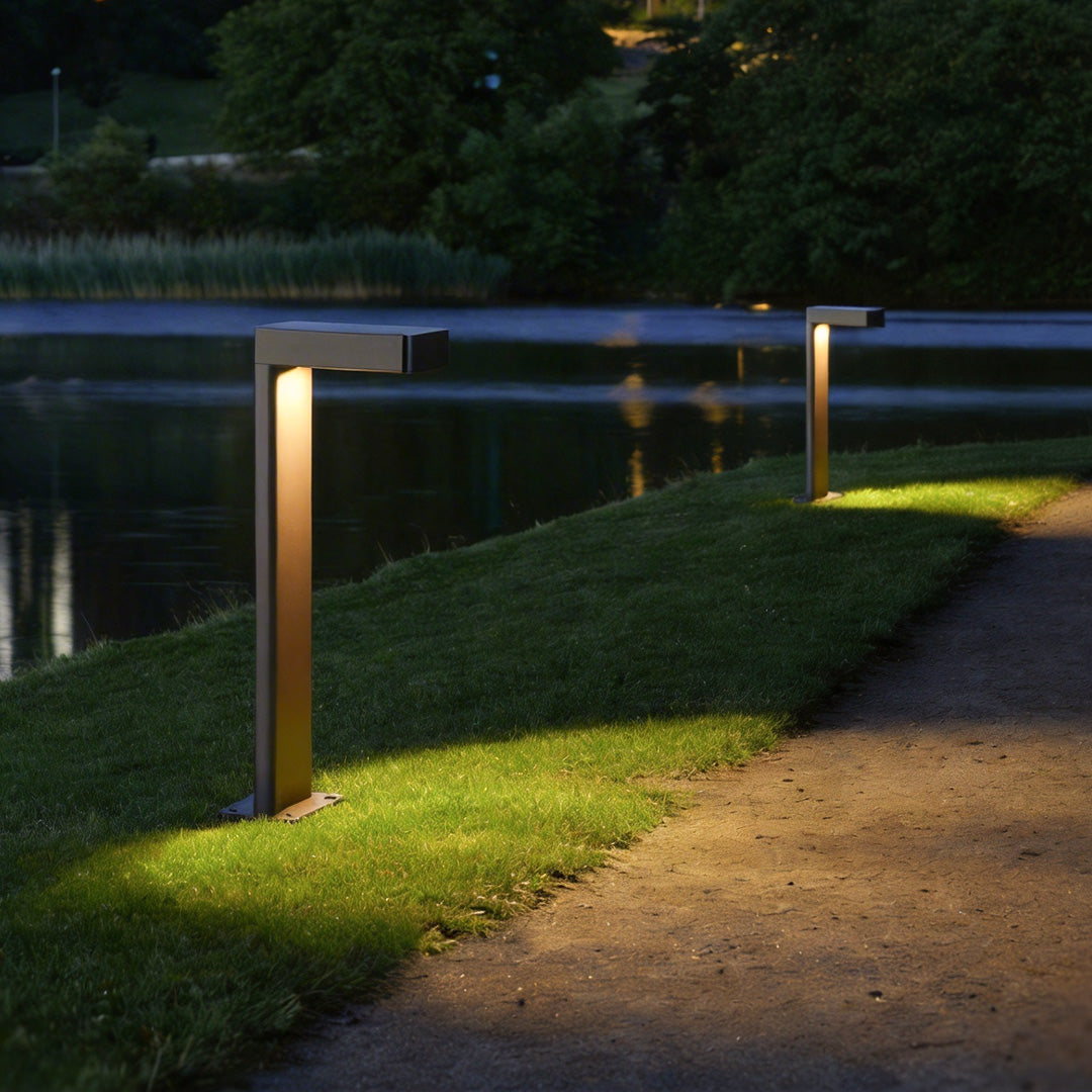 L-shaped landscape light standing along a garden walkway