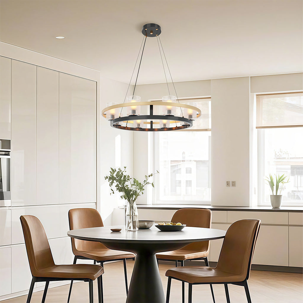 Circular wagon wheel chandelier above a table in a bright kitchen