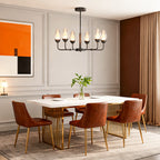 Minimalist chandelier above a dining table with orange chairs