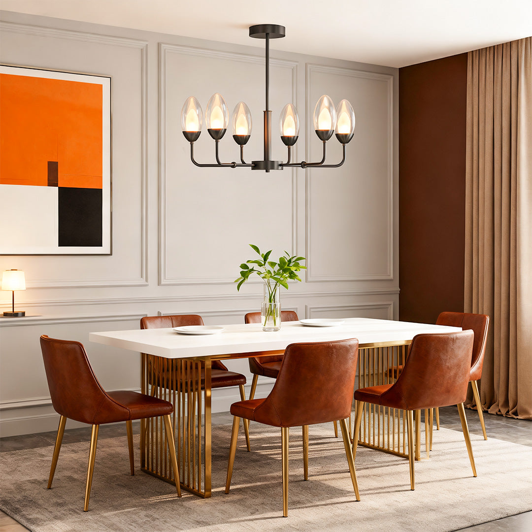 Minimalist chandelier above a dining table with orange chairs
