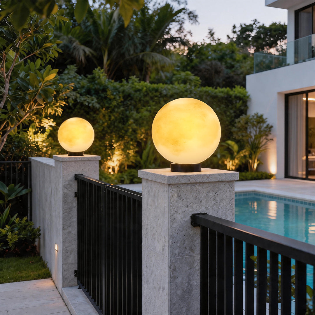 Moon pillar lights at a luxury villa entrance beside a pool