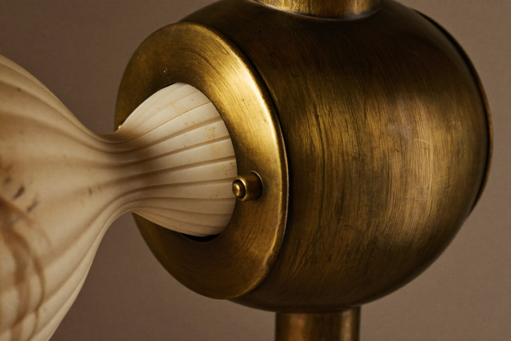 Close-up of aged brass hardware and hand-blown ribbed glass