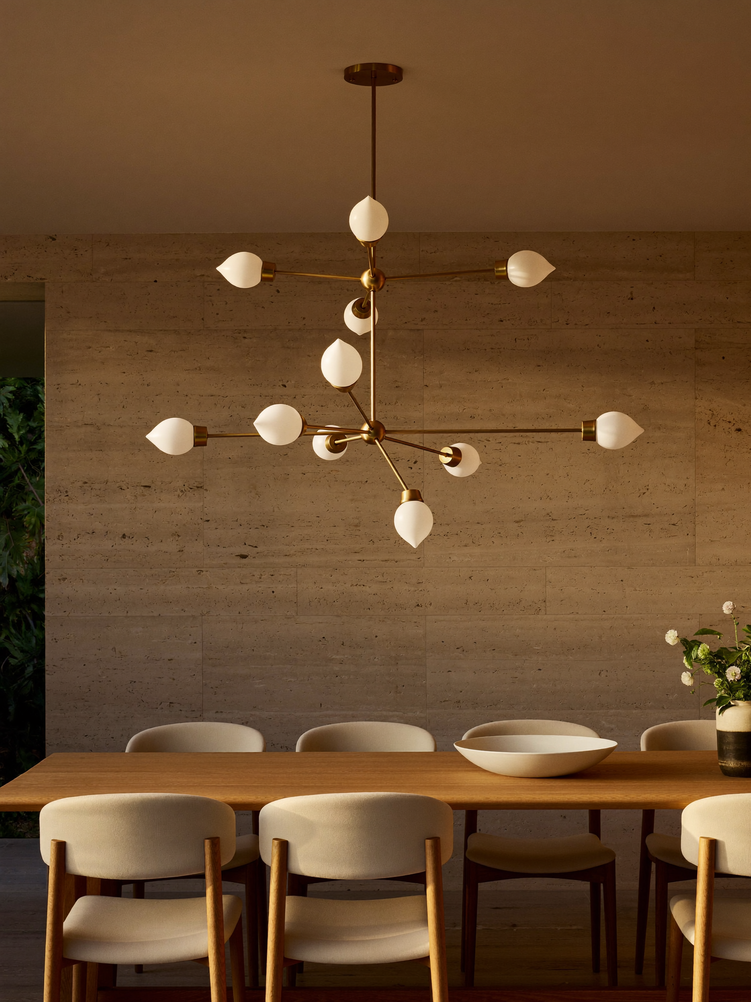 Brass and opal glass chandelier over an oak dining table