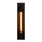Elongated black sconce fitted with a warm toned bulb