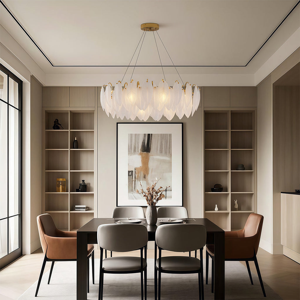 Feather chandelier above a modern dining table with black chairs