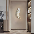 Illuminated feather wall art panel lighting a narrow corridor