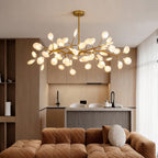 Firefly branching pendant light hanging above a living room sofa