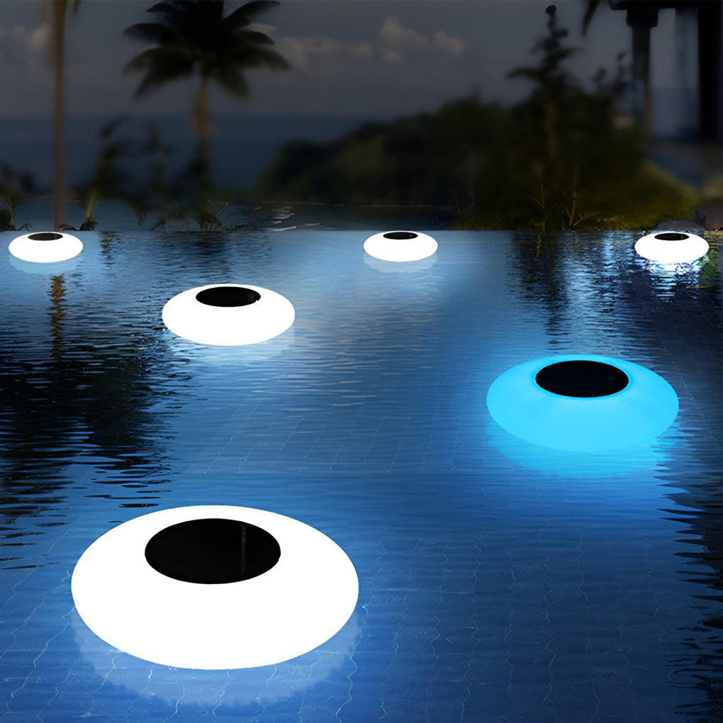Floating pond light glowing on a dark water surface at night