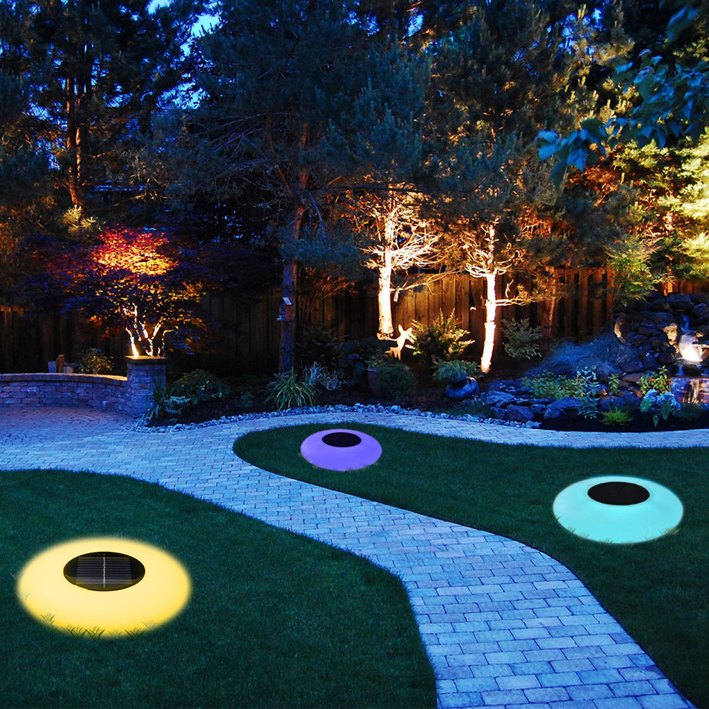 Floating globe light used as decoration beside an outdoor pathway