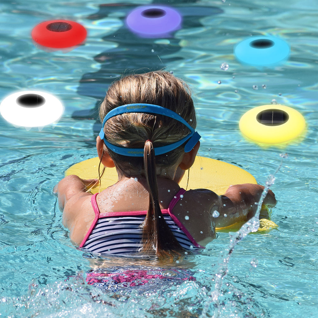 Floating globe light drifting in a swimming pool