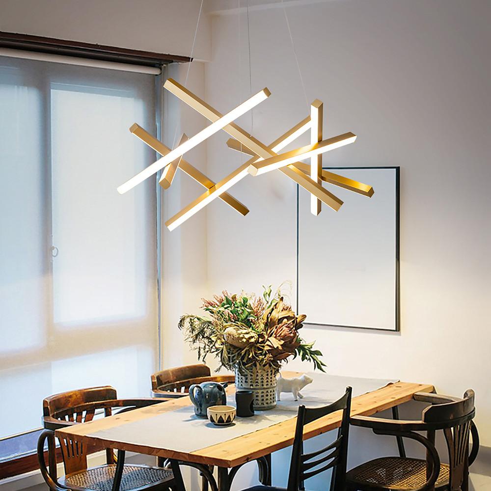 Gold and white geometric ceiling light in a dining room