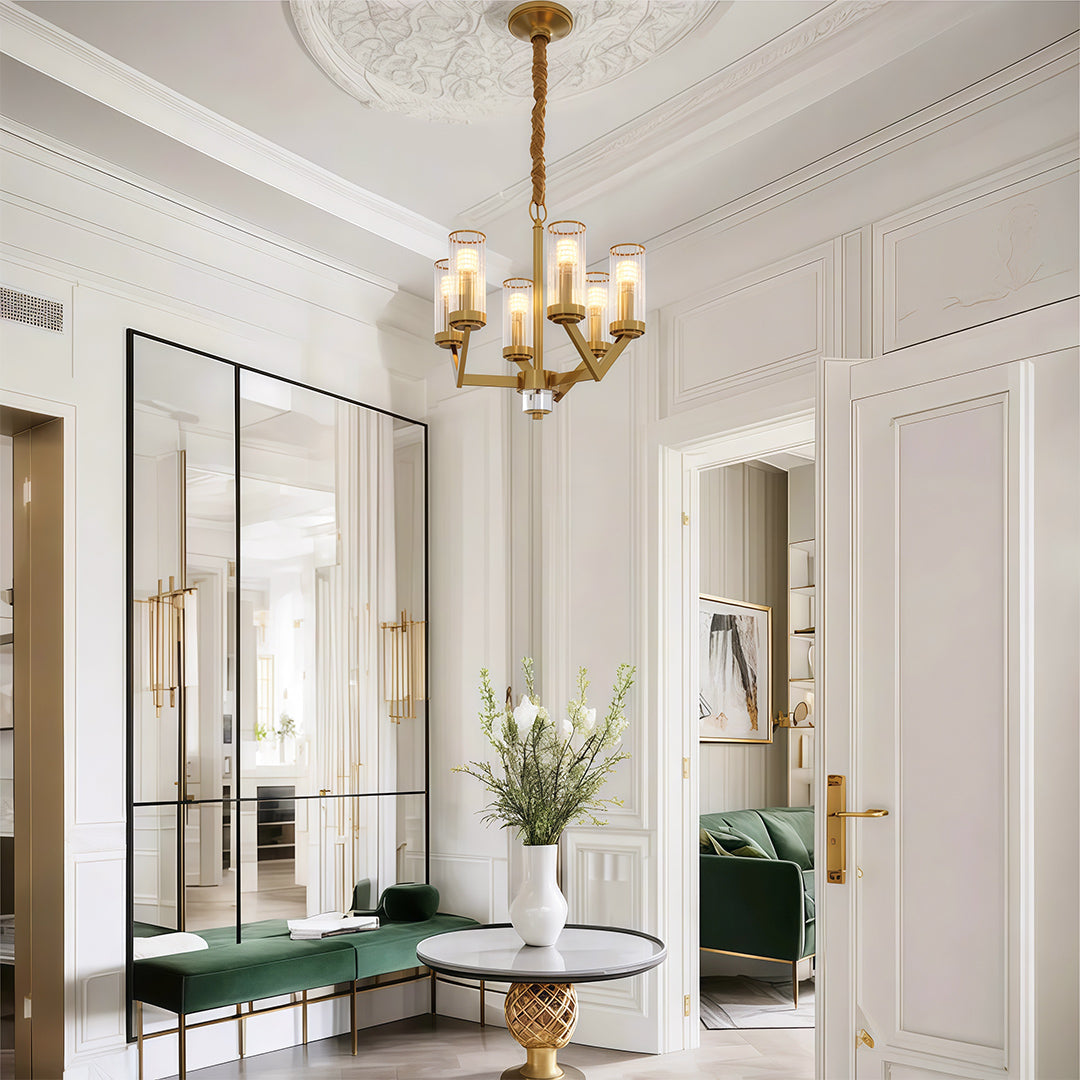 Glass drop chandelier in a neutral room beside artwork