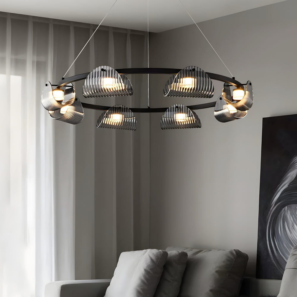 Glass ring chandelier glowing warm in a bedroom
