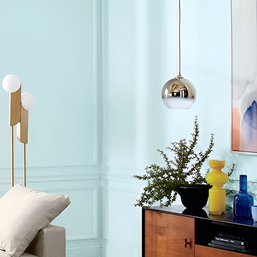 Two glass globe pendant lights installed side by side