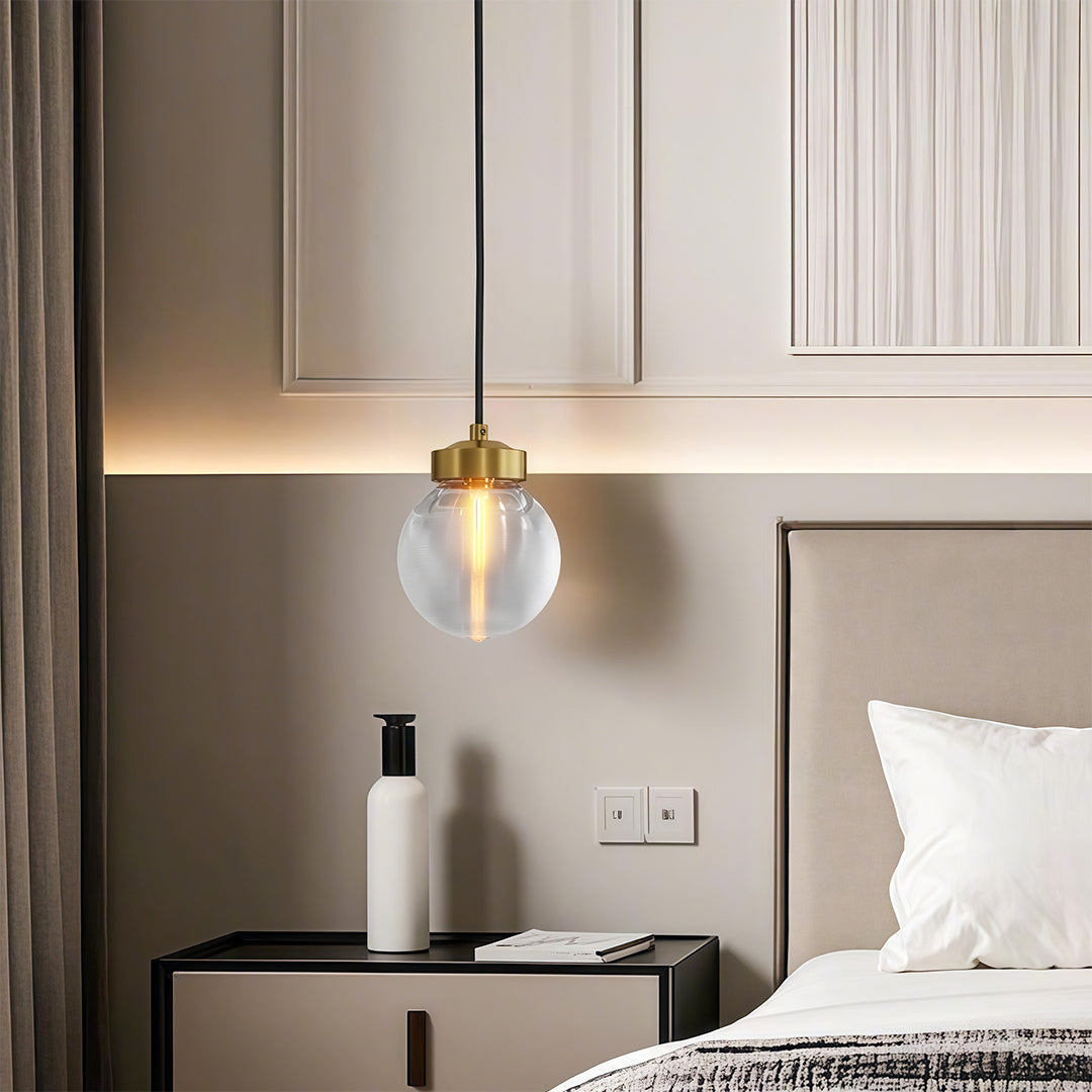 Glass semi flush light beside a bed with white bedding