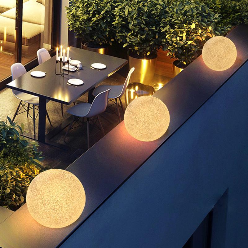 White globe pillar light mounted on a balcony railing