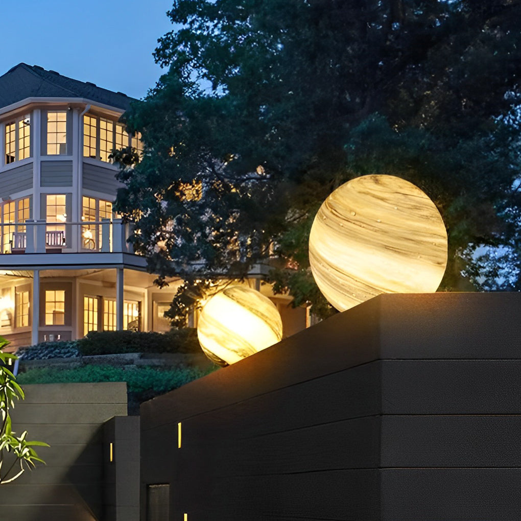 Globe pillar light giving soft light in a garden at night