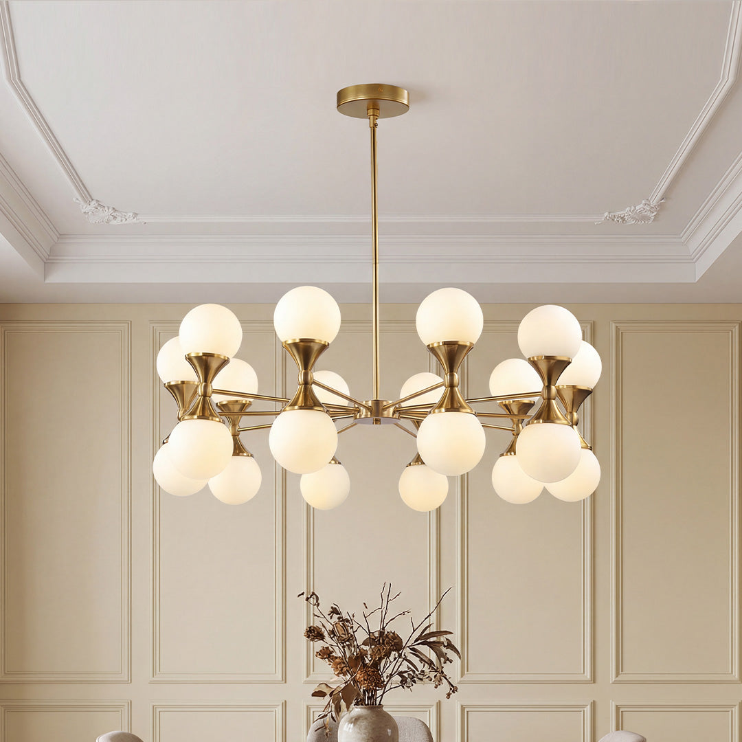 Gold bubble chandelier with frosted globes against wainscoting