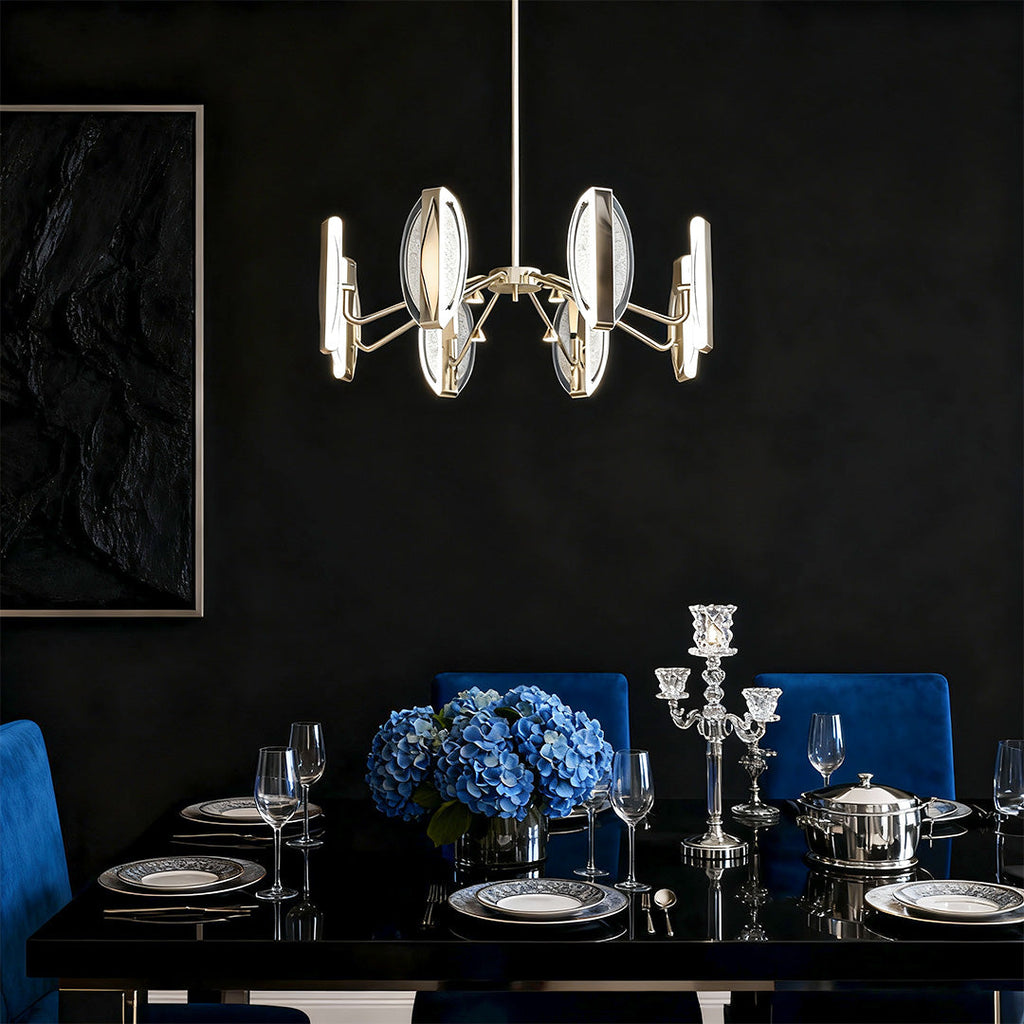 Gold chandelier in a dark dining room with blue accents