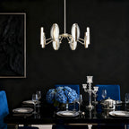 Gold chandelier in a dark dining room with blue accents