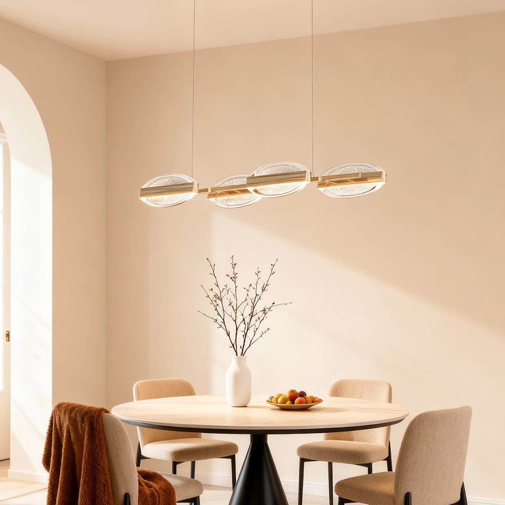 Gold chandelier above a dining table with wooden chairs