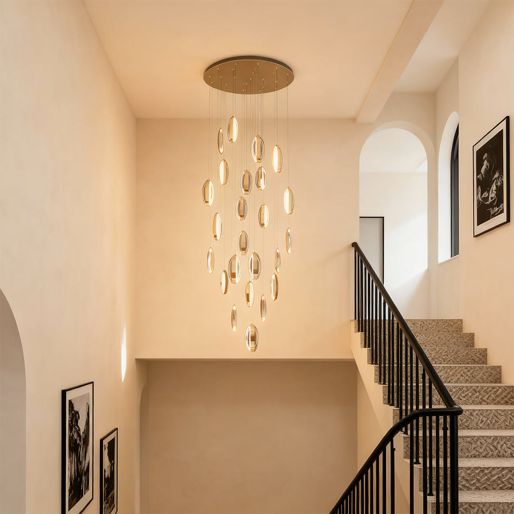 Gold mobius chandelier in a bright neutral hallway