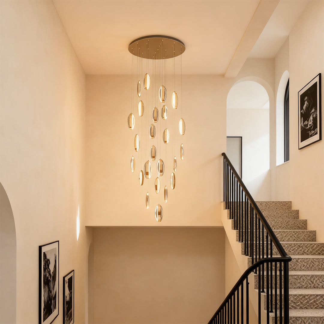 Gold mobius chandelier in a bright neutral hallway