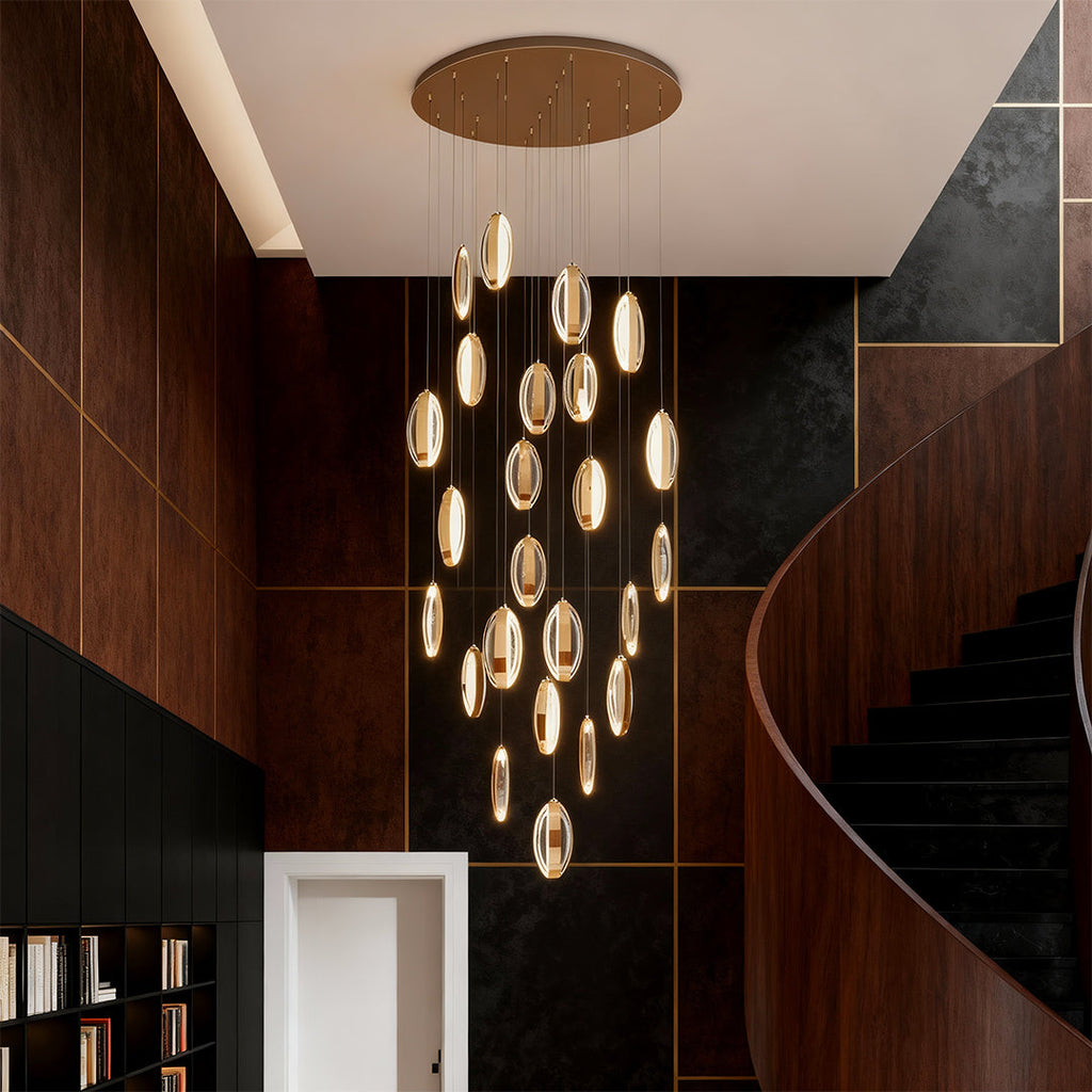 Gold mobius chandelier in a curved stairwell with wood panelling
