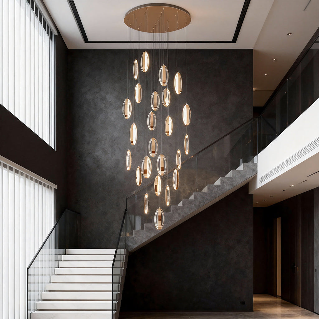 Gold mobius chandelier in an entryway with black walls